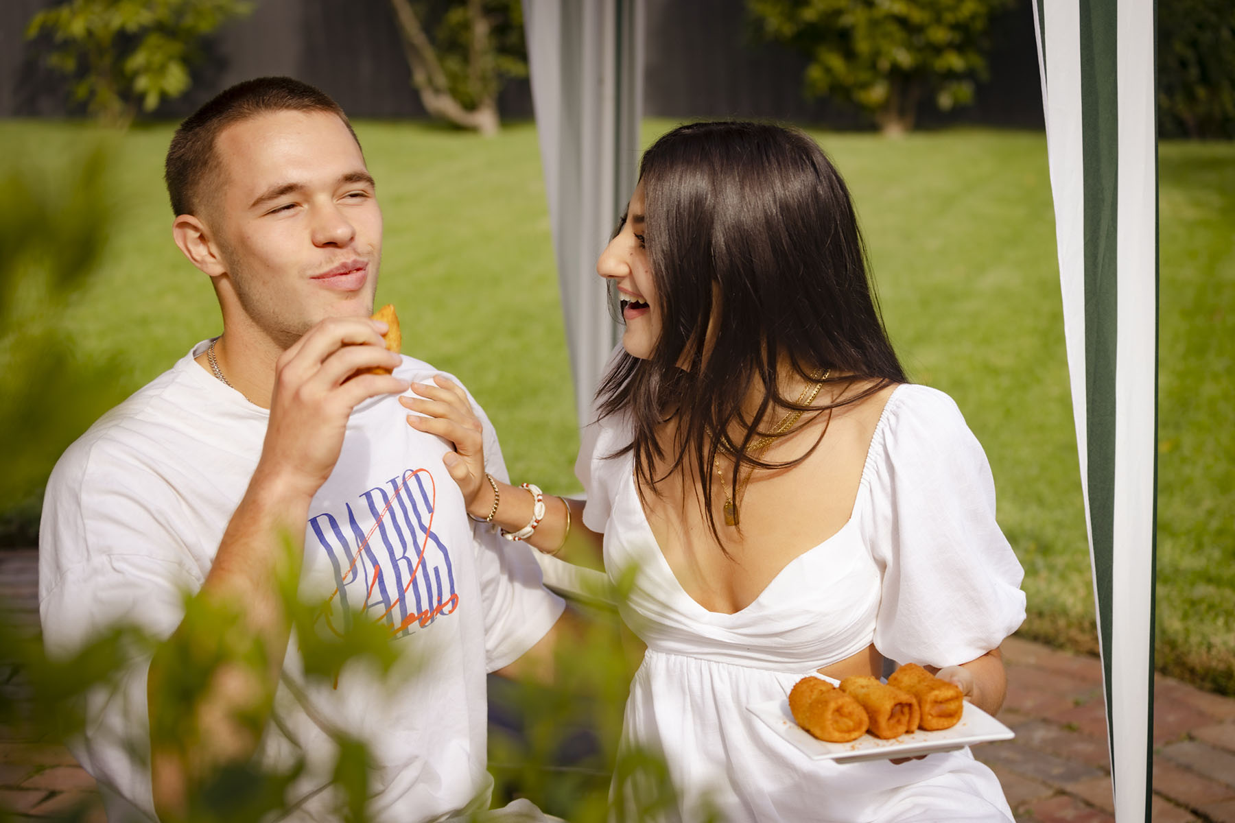 Young couple laugh and enjoy Beef Pan Rolls.