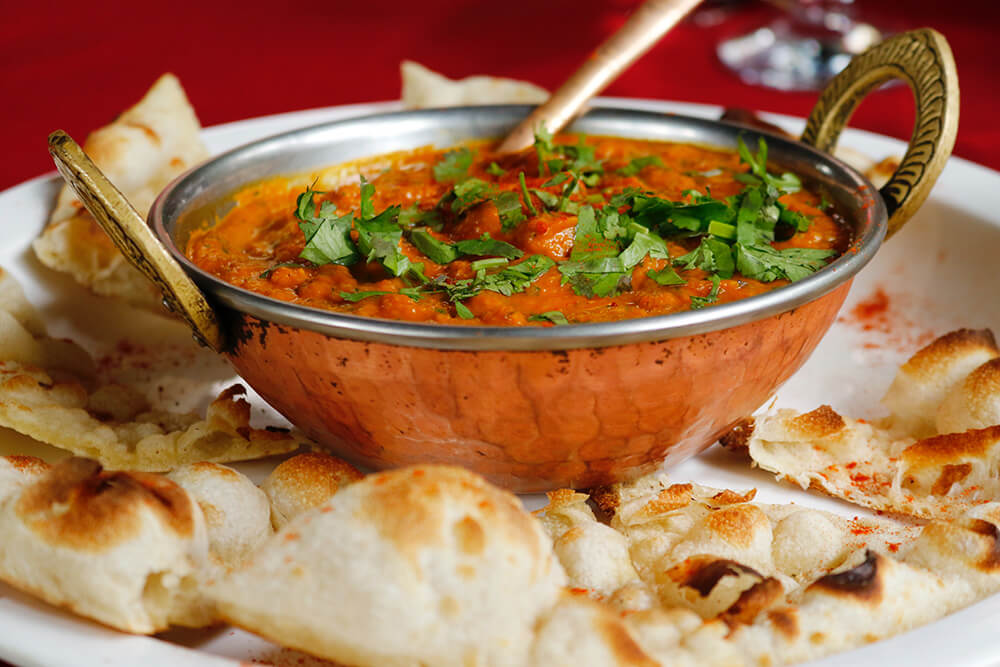 Delicious Sri Lankan Dahl Curry in a traditional bowl with Naan bread.